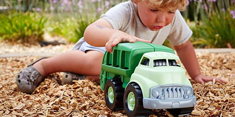 Child Playing With Green Toys Truck